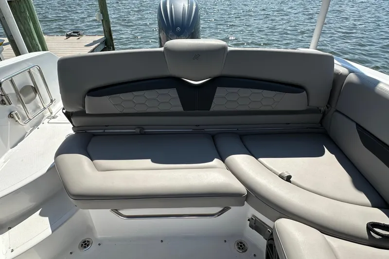 Slide: The Image of 2022 Four Winns HD8 OB boat interior with gray seating and water view. - 15