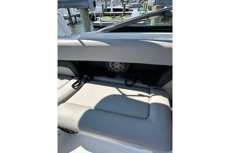 Slide: The Image of 2022 Four Winns HD8 OB boat interior with gray seating and speaker detail. - 17