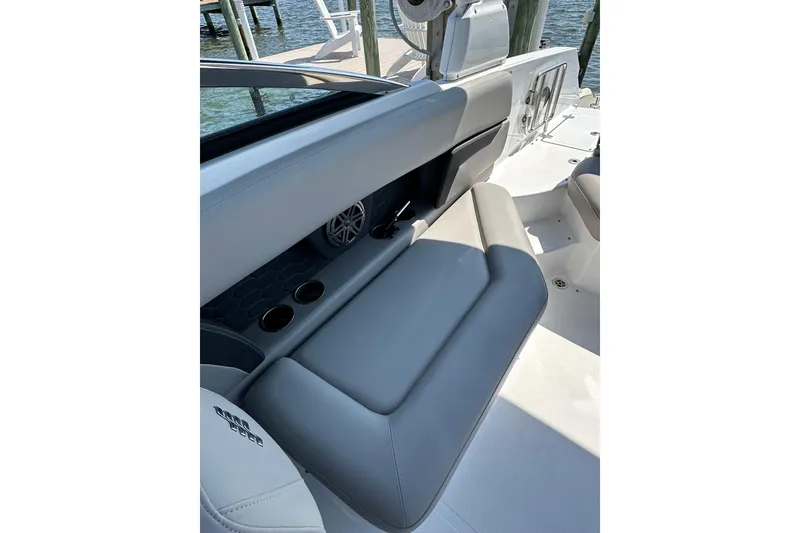 Slide: The Image of 2022 Four Winns HD8 OB boat interior with gray seating and cup holders. - 18