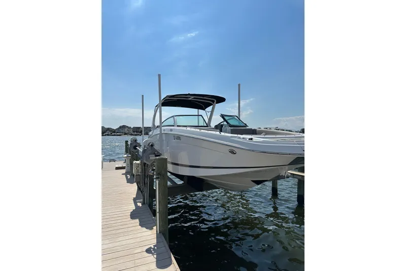 Slide: The Image of 2022 Four Winns HD8 OB boat docked on a sunny day. - 2