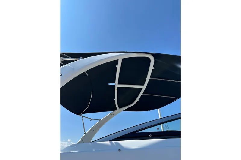 Slide: The Image of 2022 Four Winns HD8 OB boat canopy against clear blue sky. - 22