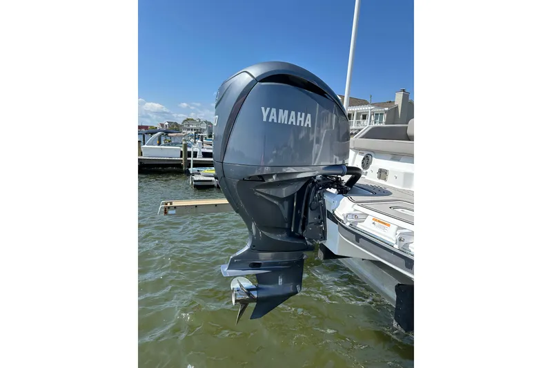 Slide: The Image of 2022 Four Winns HD8 OB with Yamaha outboard motor at a marina. - 25