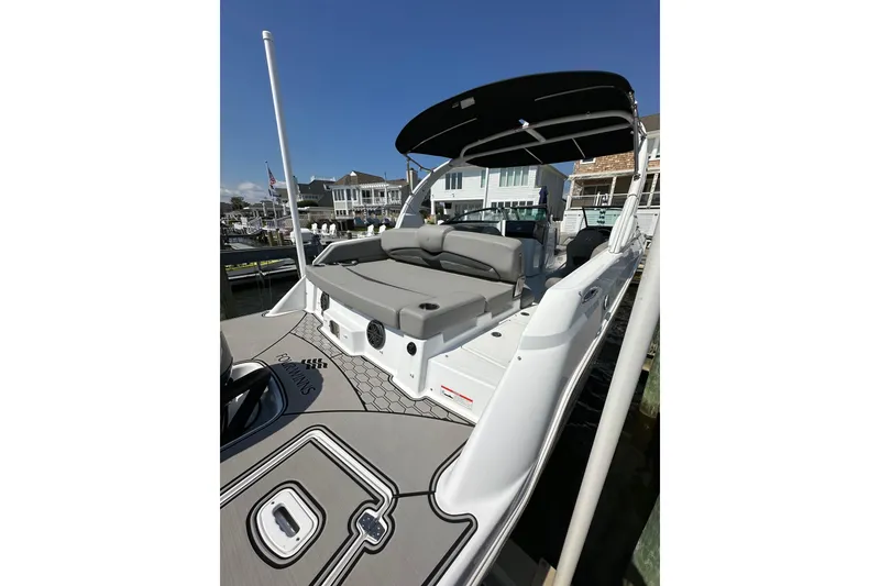 Slide: The Image of 2022 Four Winns HD8 OB boat with spacious seating and sleek design at a dock. - 4