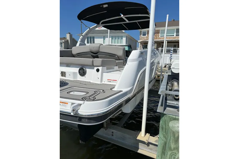 Slide: The Image of 2022 Four Winns HD8 OB boat docked, featuring sleek design and spacious seating. - 5