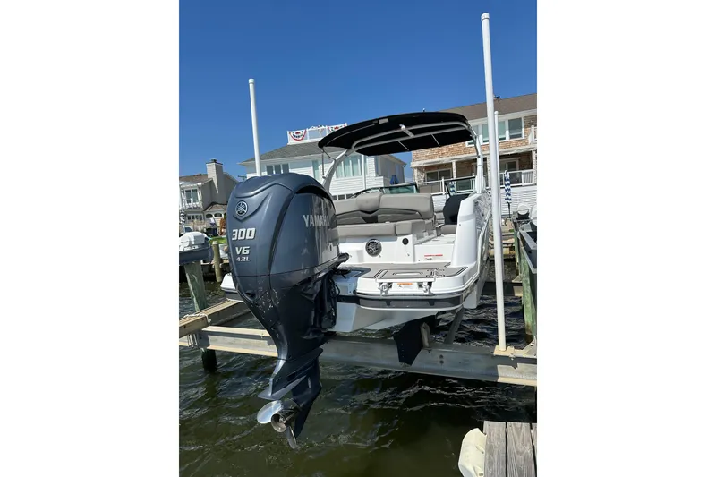 Slide: The Image of 2022 Four Winns HD8 OB boat with Yamaha 300 V6 engine docked by waterfront homes. - 6