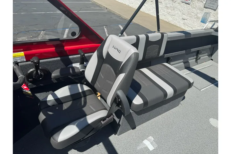 Slide: The Image of 2026 Lund 210 Heavy Gauge boat interior with gray and black seating. - 20