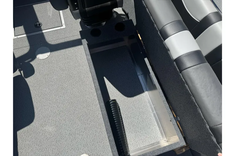 Slide: The Image of Interior view of 2026 Lund 210 Heavy Gauge boat, featuring seating and storage area. - 22