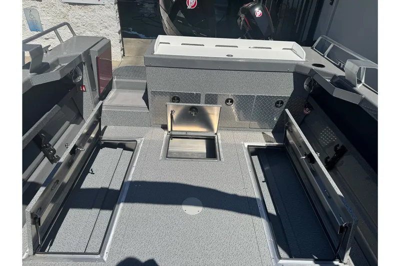 Slide: The Image of 2026 Lund 210 Heavy Gauge boat interior with storage compartments and sleek design. - 24
