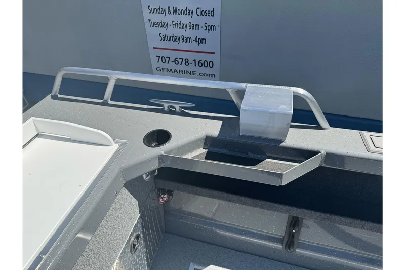 Slide: The Image of 2026 Lund 210 Heavy Gauge boat interior with storage and railing details. - 26