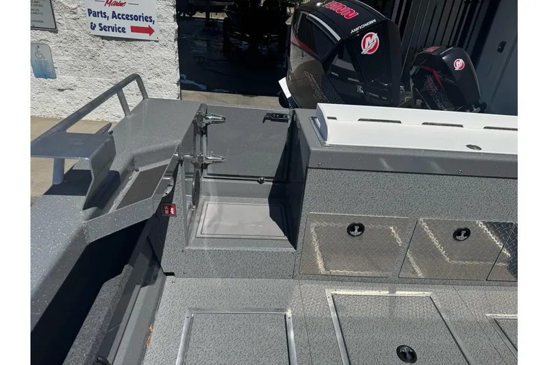 Slide: The Image of 2026 Lund 210 Heavy Gauge boat interior with storage compartments and Mercury outboard motors. - 28