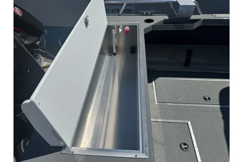 Slide: The Image of Open storage compartment in 2026 Lund 210 Heavy Gauge boat interior. - 29