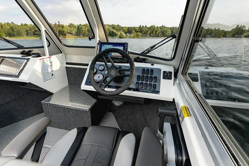Slide: The Image of Manufacturer Provided Image: Interior of 2025 Lund 210 Heavy Gauge boat with modern dashboard and steering wheel. - 3