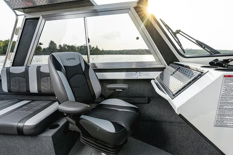 Slide: The Image of Manufacturer Provided Image: Interior of 2025 Lund 210 Heavy Gauge boat with modern seating and dashboard. - 4