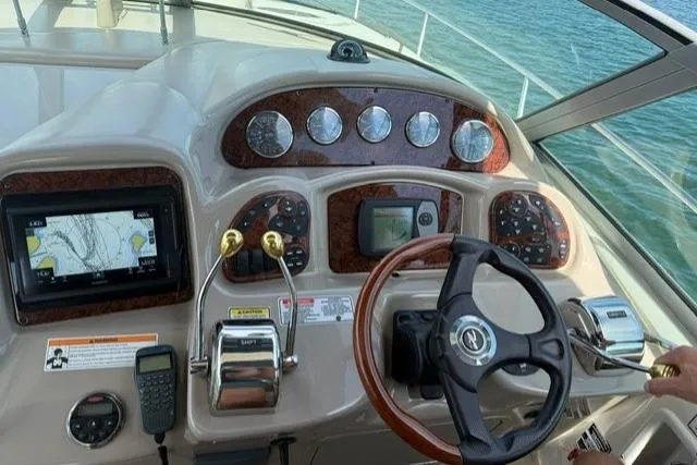 Slide: The Image of Helm of 2006 Sea Ray Sundancer 320 with navigation instruments and steering wheel. - 16