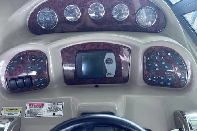 Slide: The Image of Dashboard of a 2006 Sea Ray Sundancer 320 boat with gauges and controls. - 17