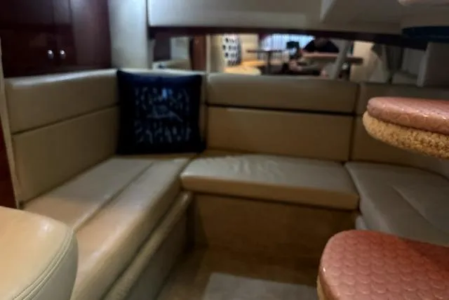Slide: The Image of Interior of 2006 Sea Ray Sundancer 320 yacht with beige seating and a decorative pillow. - 23
