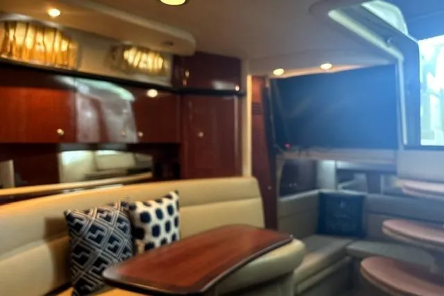 Slide: The Image of Interior of 2006 Sea Ray Sundancer 320 yacht with plush seating and wooden accents. - 24