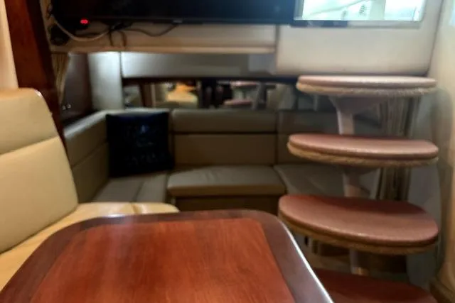 Slide: The Image of Interior of 2006 Sea Ray Sundancer 320 yacht with seating and wooden table. - 26