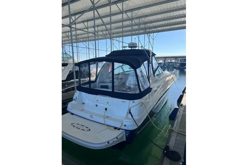 Slide: The Image of 2006 Sea Ray Sundancer 320 docked under a covered marina. - 3