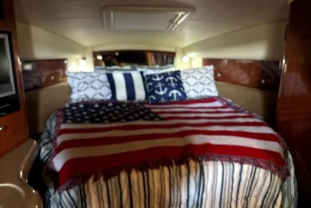 Slide: The Image of Cozy cabin interior of 2006 Sea Ray Sundancer 320 with nautical-themed bedding. - 30