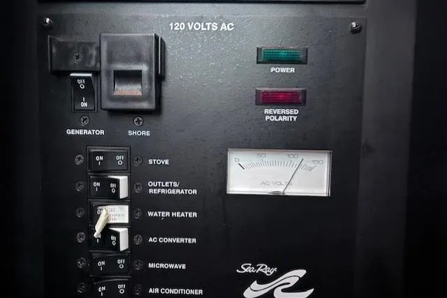 Slide: The Image of Electrical panel of 2006 Sea Ray Sundancer 320 boat, showing power controls and indicators. - 31
