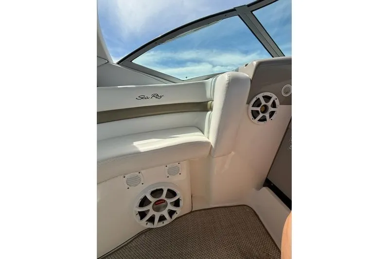 Slide: The Image of Interior of a 2006 Sea Ray Sundancer 320 boat, featuring white seating and speakers. - 7