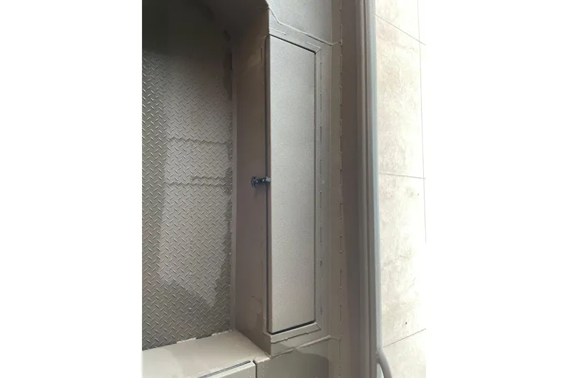 Slide: The Image of Storage compartment on 2026 Reaper Boats 653 Timber Reaper, featuring a secure latch and textured surface. - 17