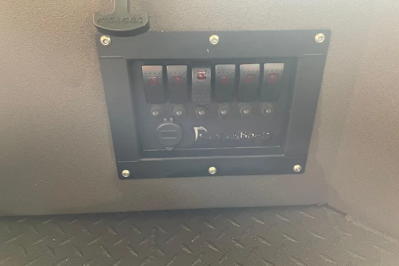 Slide: The Image of Control panel of 2026 Reaper Boats 653 Timber Reaper with switches and textured flooring. - 20