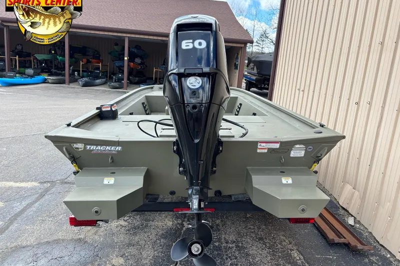 Slide: The Image of 2023 Tracker Grizzly 1860 CC boat with 60 HP motor, parked outdoors. - 3