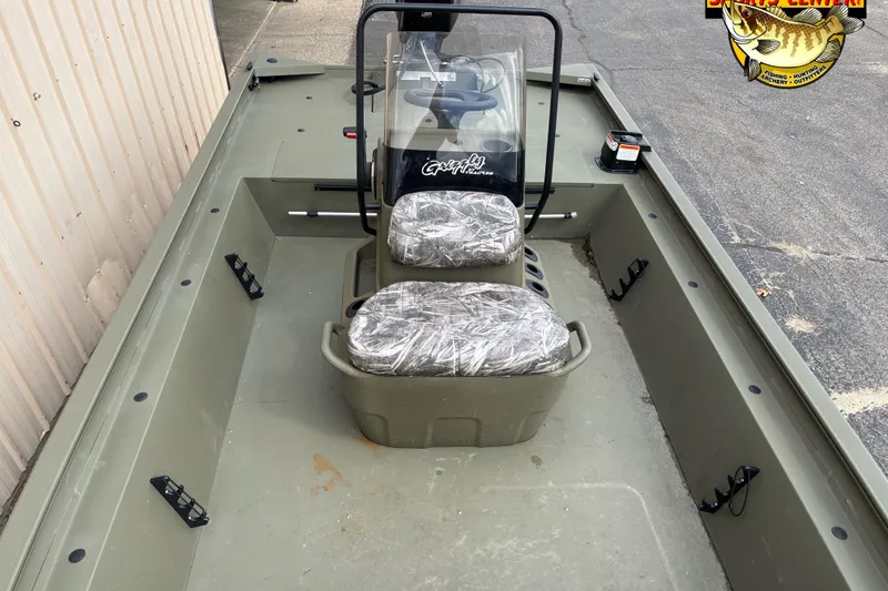 Slide: The Image of 2023 Tracker Grizzly 1860 CC boat interior with camouflage seats and steering console. - 6