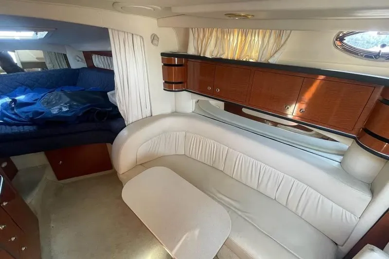 Slide: The Image of Interior of 2003 Sea Ray 300 Sundancer with seating and wooden cabinetry. - 11