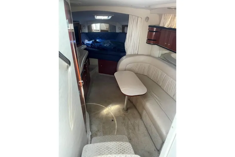 Slide: The Image of Interior of 2003 Sea Ray 300 Sundancer with seating, table, and bed. - 12
