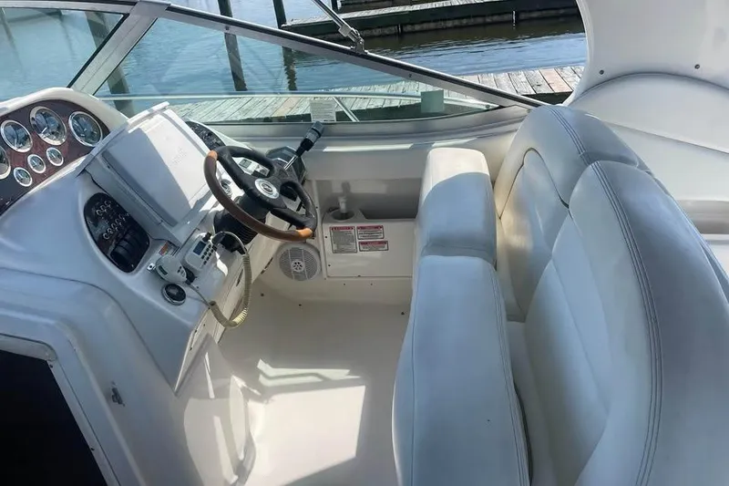 Slide: The Image of Cockpit of 2003 Sea Ray 300 Sundancer with steering wheel and control panel. - 7