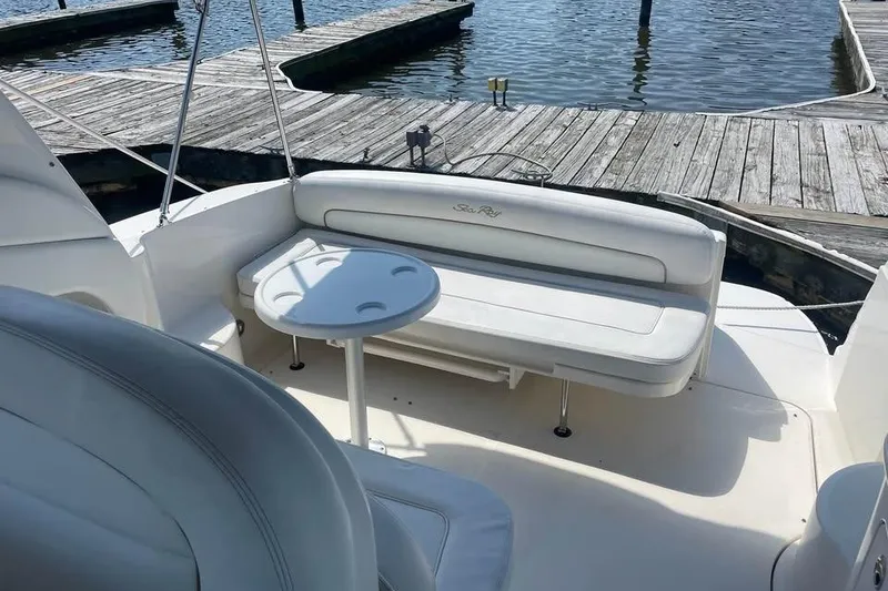 Slide: The Image of 2003 Sea Ray 300 Sundancer boat interior with seating and table at dock. - 8