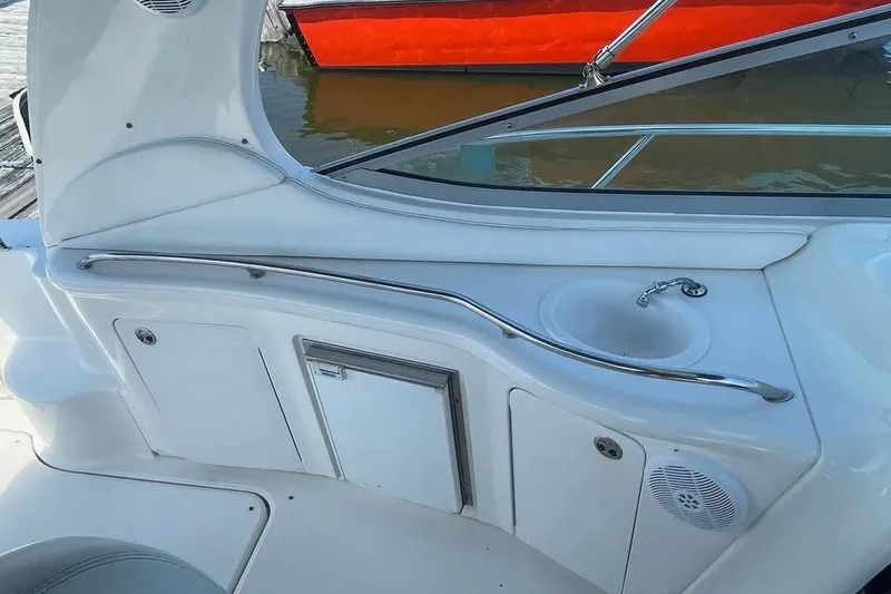 Slide: The Image of 2003 Sea Ray 300 Sundancer boat interior with sink and storage compartments. - 9