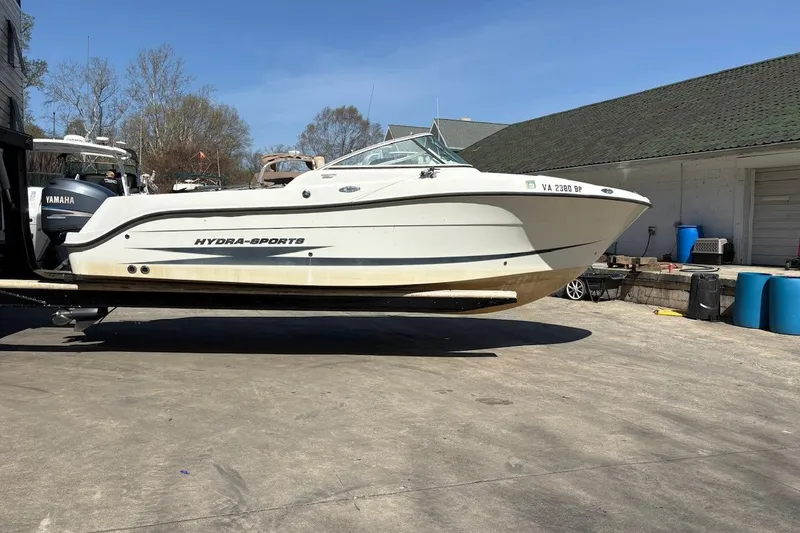Slide: The Image of 2009 Hydra-Sports 2200 DC boat on trailer, Yamaha engine, outdoor setting. - 2