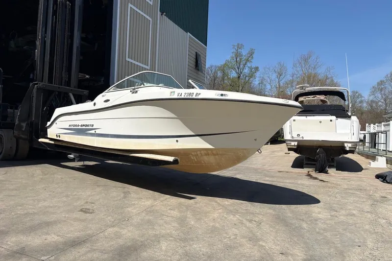 Slide: The Image of 2009 Hydra-Sports 2200 DC boat being lifted by a forklift near a dock. - 3