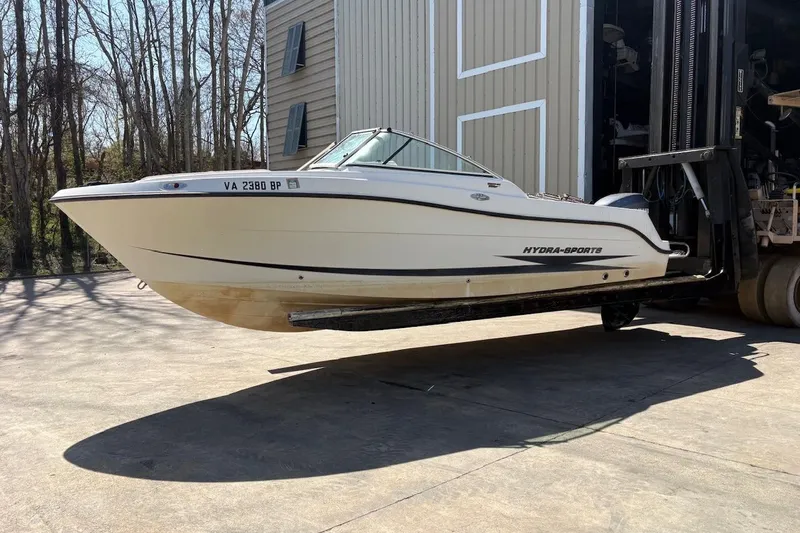 Slide: The Image of 2009 Hydra-Sports 2200 DC boat on forklift, outdoors near storage facility. - 9