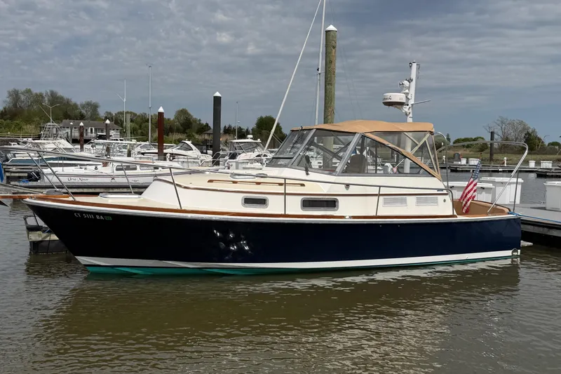 Slide: The Image of 2001 Bluestar BlueStar 29.9 boat docked in marina, featuring classic design and American flag. - 39