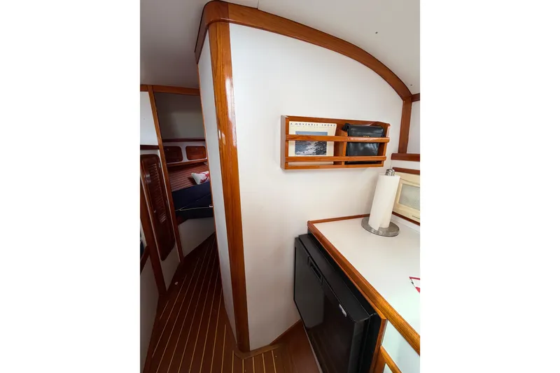 Slide: The Image of Interior of 2001 Bluestar BlueStar 29.9 boat with wooden accents and compact kitchen area. - 21