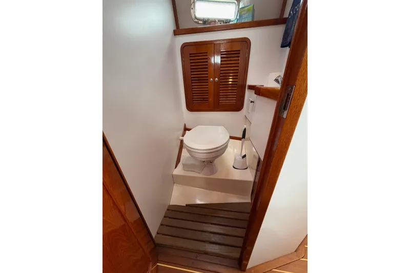 Slide: The Image of Compact boat bathroom with wooden accents in 2001 Bluestar BlueStar 29.9 model. - 28