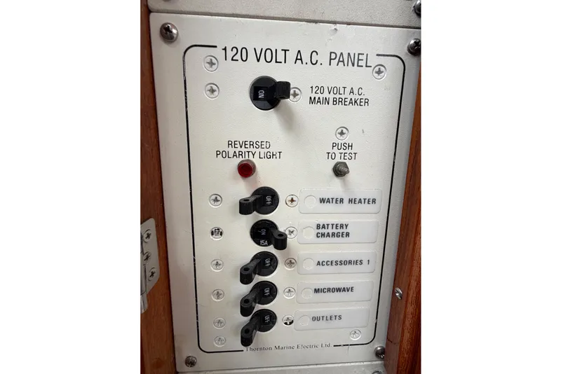 Slide: The Image of 120 Volt A.C. panel on 2001 Bluestar BlueStar 29.9 boat, featuring multiple switches. - 25