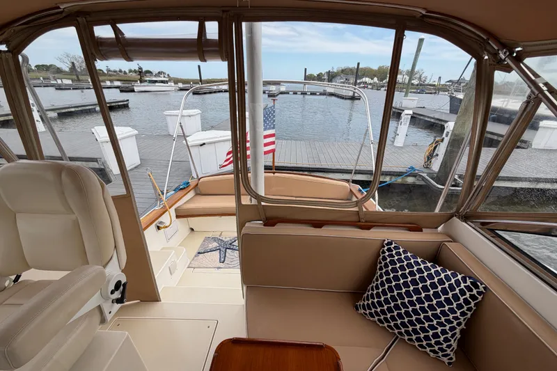 Slide: The Image of Interior view of 2001 Bluestar BlueStar 29.9 boat docked at marina with seating area. - 7