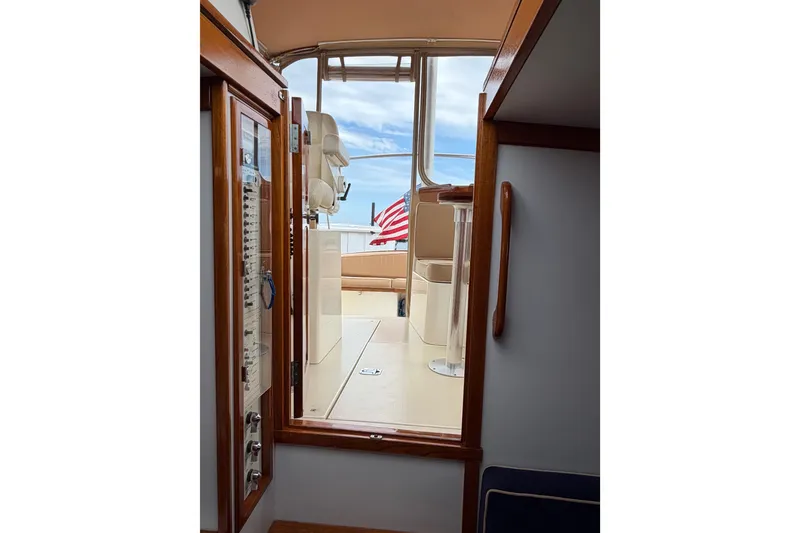Slide: The Image of Interior view of 2001 Bluestar BlueStar 29.9 boat, featuring wooden accents and American flag. - 35