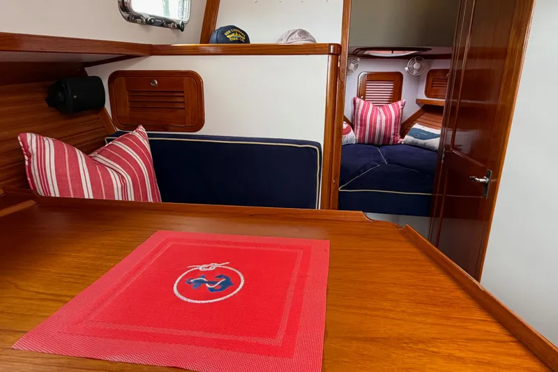 Slide: The Image of Cozy interior of 2001 Bluestar BlueStar 29.9 boat with striped pillows and wooden finish. - 17