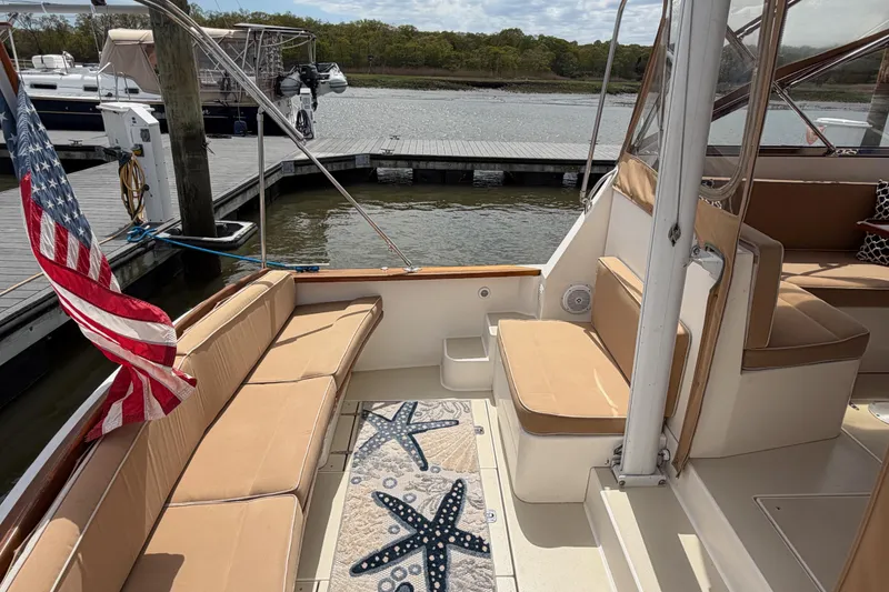 Slide: The Image of Interior of 2001 Bluestar BlueStar 29.9 boat with seating and American flag. - 2