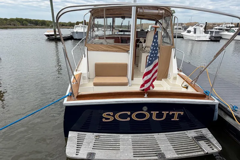 Slide: The Image of Bluestar 29.9 boat named "Scout" docked, featuring American flag, 2001 model. - 38