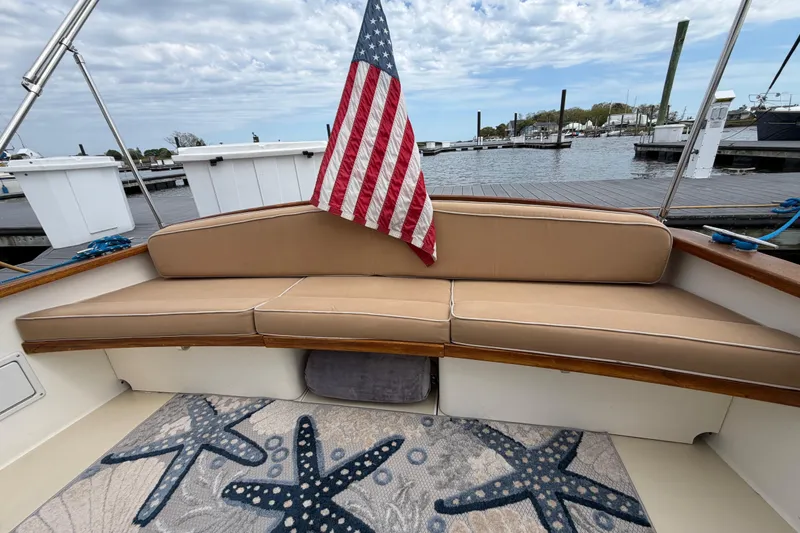 Slide: The Image of 2001 Bluestar BlueStar 29.9 boat with American flag, docked at marina, starfish-patterned rug. - 3