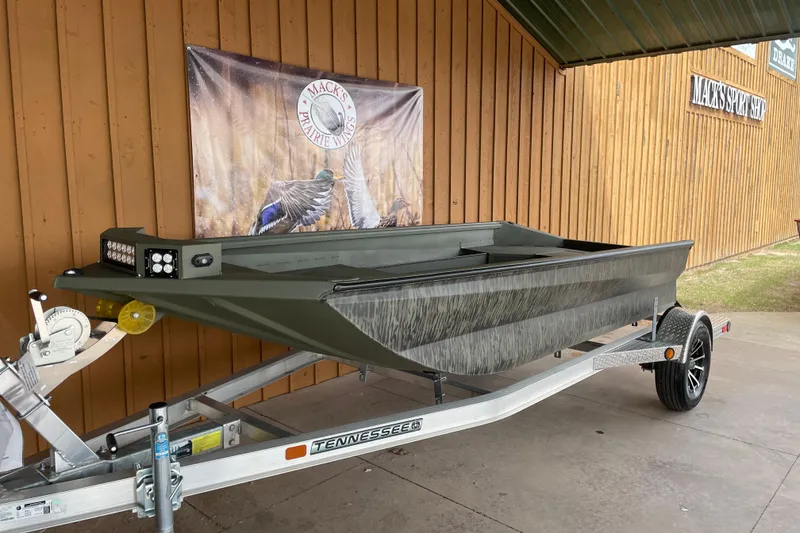The Image of 2026 Reaper Boats 553 Timber Reaper on trailer, displayed outside Mack's Prairie Wings. - 1