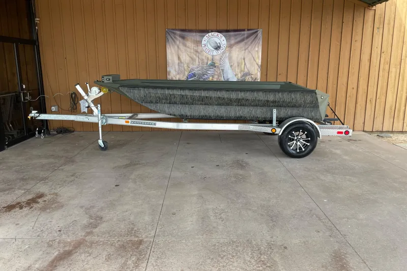 Slide: The Image of 2026 Reaper Boats 553 Timber Reaper on trailer, displayed outdoors. - 11